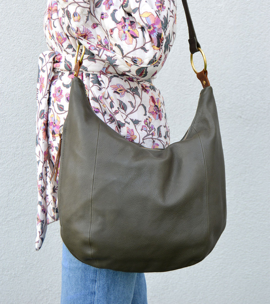 Woman in a floral jacket with the Osgoode Marley Tammi Hobo bag.