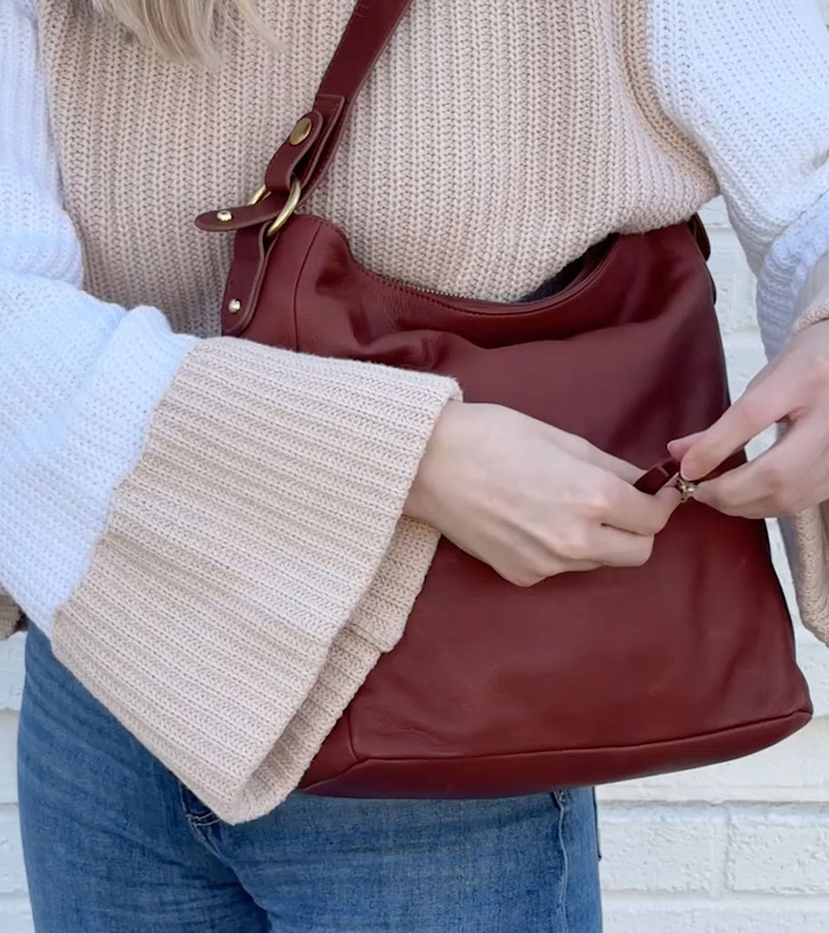 Image of woman with a brown Osgoode Marley handbag.
